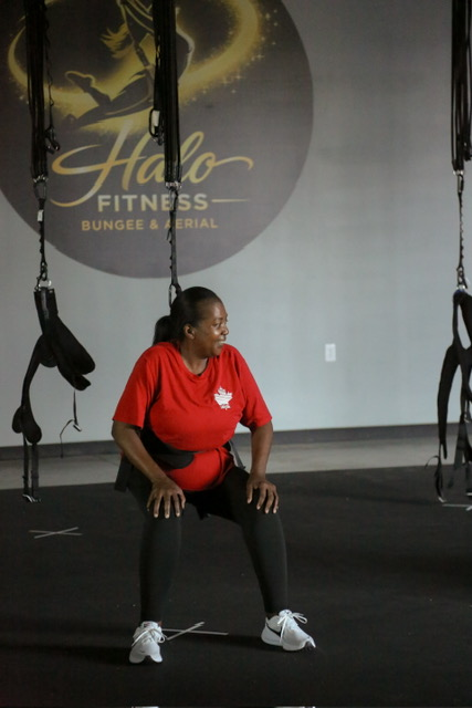 Bungee fitness class member in a squat at Halo Fitness Bungee
